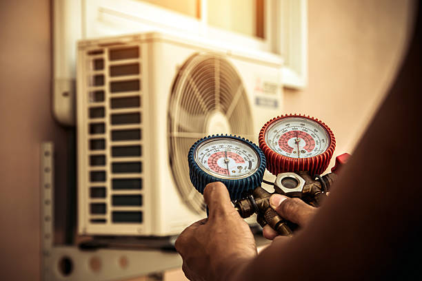 Professional Air Conditioning Service technician working in Tioga, ND
